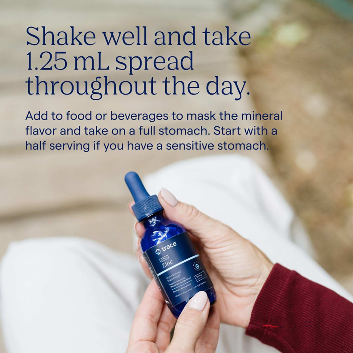 TM027 | Hand holding Trace Zinc liquid mineral supplement with usage instructions