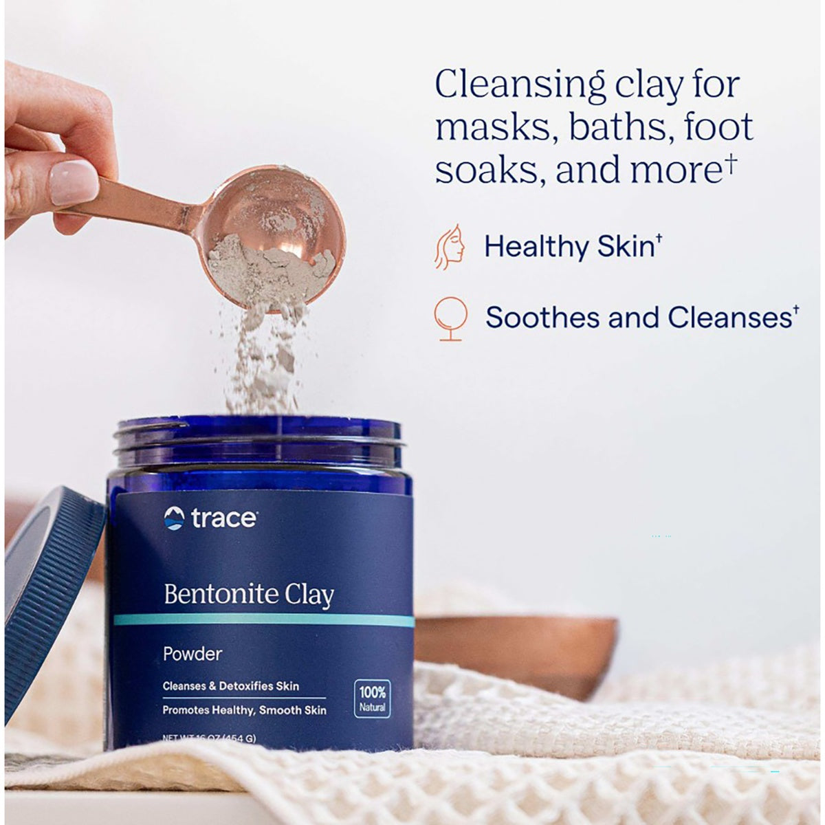 TM087 | Trace Bentonite Clay powder in a jar with a spoon pouring clay, shown for masks, baths, and foot soaks