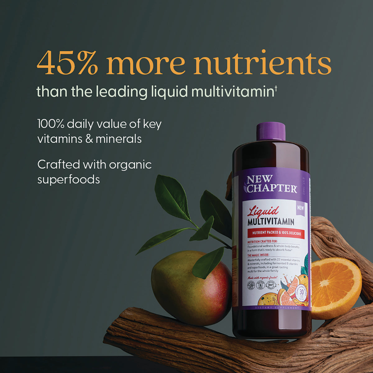 NWC393 | 45% more nutrients claim with New Chapter liquid multivitamin bottle, mango and orange on wood