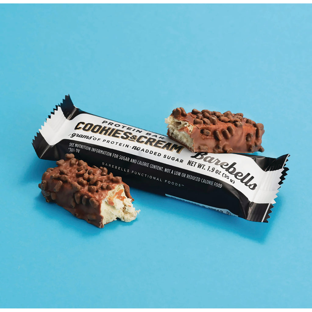 BAE003 | Back view of Cookies & Cream protein bar wrapper with two chocolate-covered broken bars on a blue background - Thumbnail