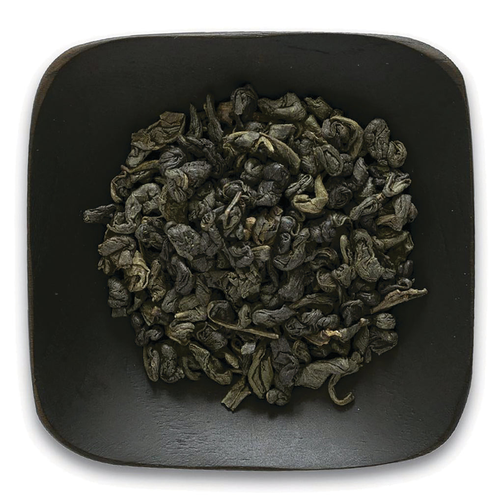 FNP082 | Top-down view of rolled green tea leaves in a dark square dish - Thumbnail