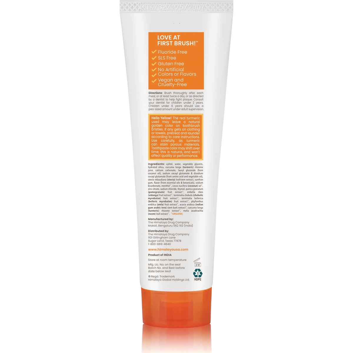 HHH055 | Back of white toothpaste tube with orange cap and orange panel reading LOVE AT FIRST BRUSH and ingredient text