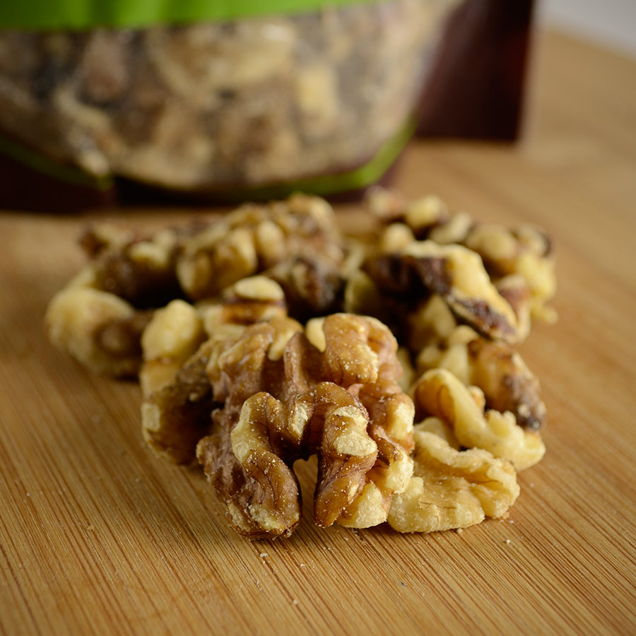 NWF1131 | close-up of shelled walnut halves on a wooden cutting board - Thumbnail