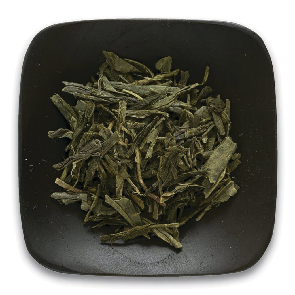 FNP084 | loose green tea leaves on a square black dish, top-down view - Thumbnail