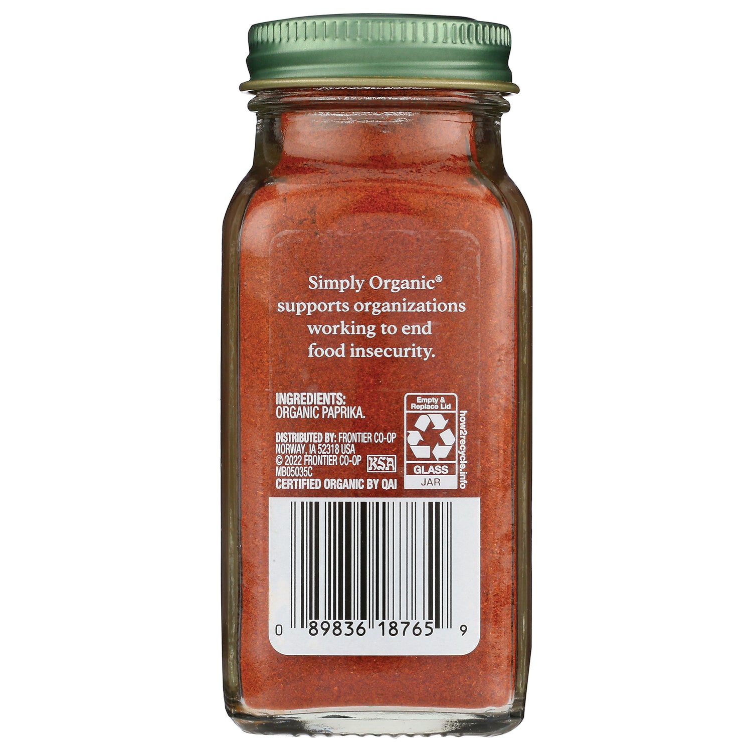 Back of glass jar of organic paprika showing ingredients text, recycling symbol and barcode