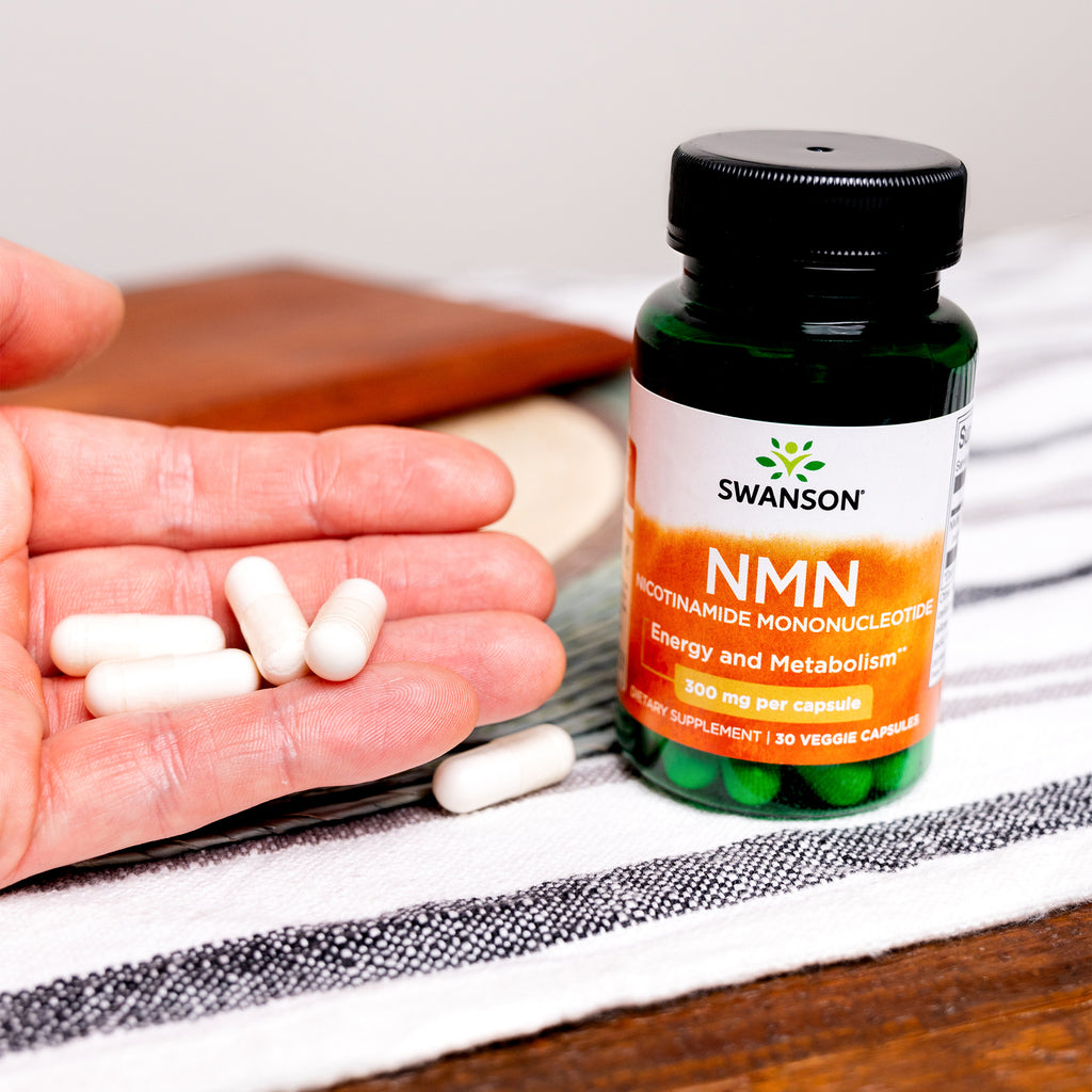 SW1819 | Swanson NMN bottle beside a hand holding veggie capsules - Thumbnail