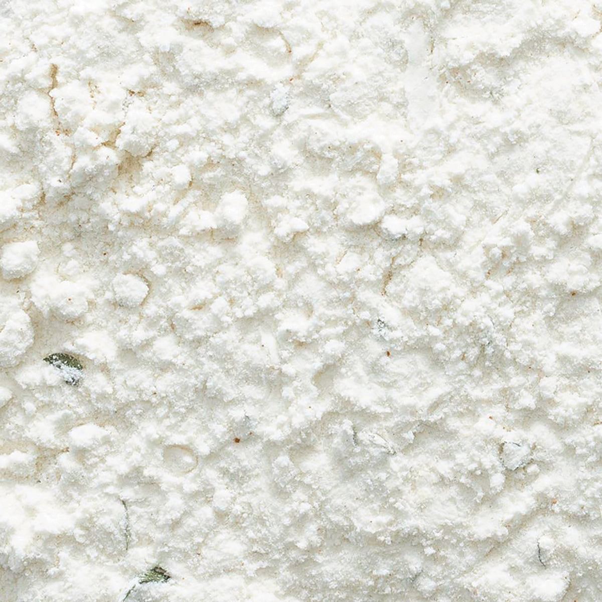 FNP042 | close-up of white powder with small green herb flecks and granular texture