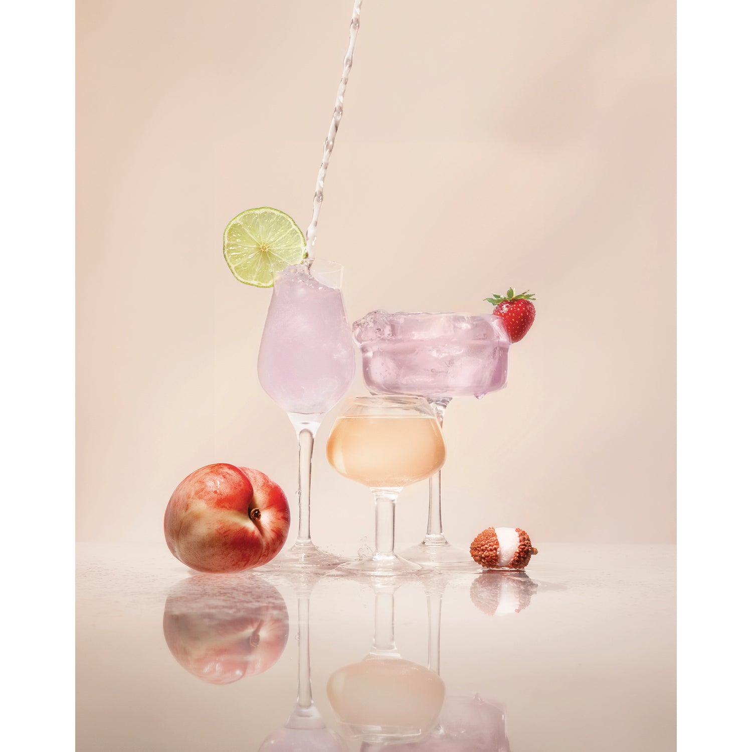 KTO004 | Pastel cocktails garnished with lime, strawberry, peach, and lychee on a reflective surface