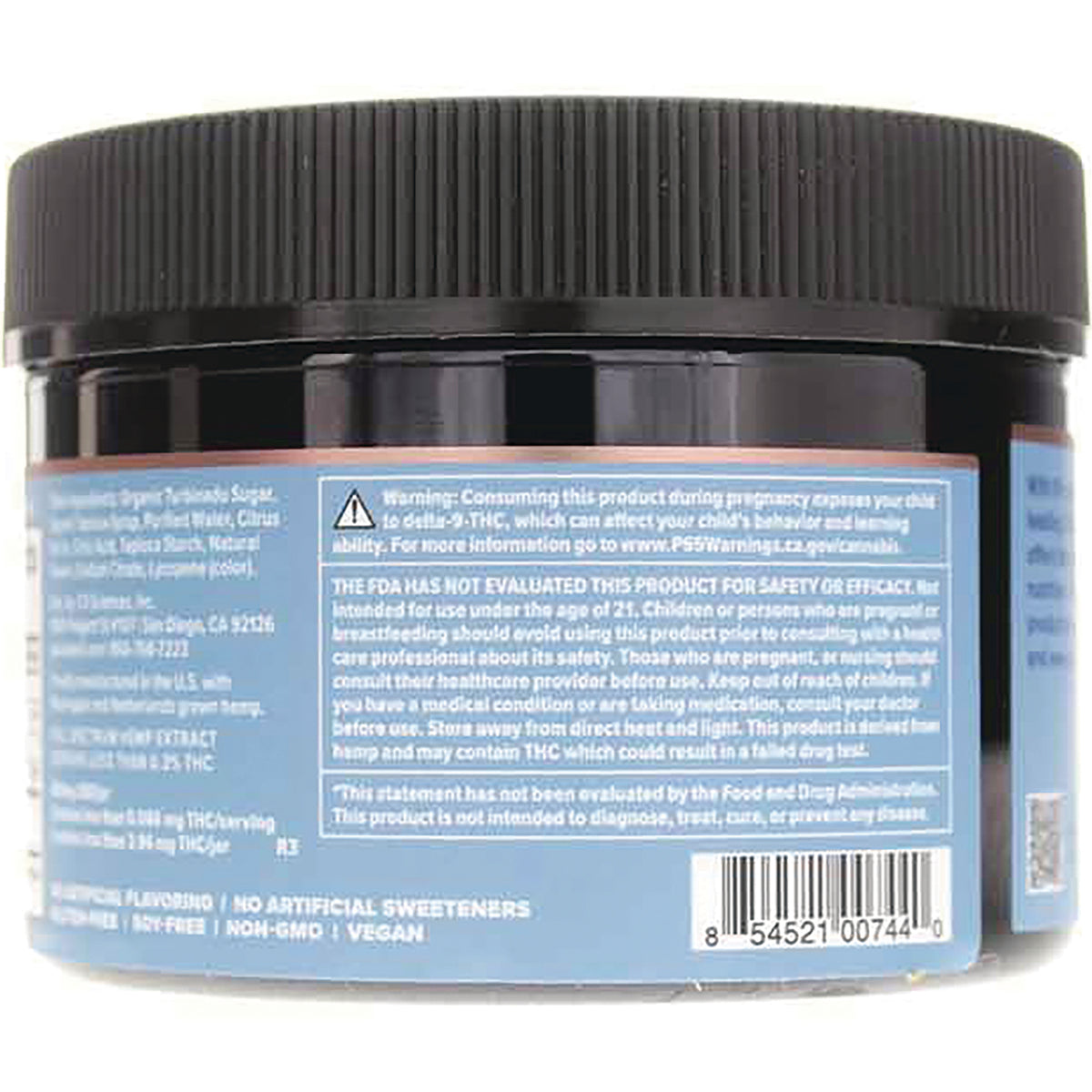Back label of black-lidded supplement jar showing warning text, ingredient panel and barcode