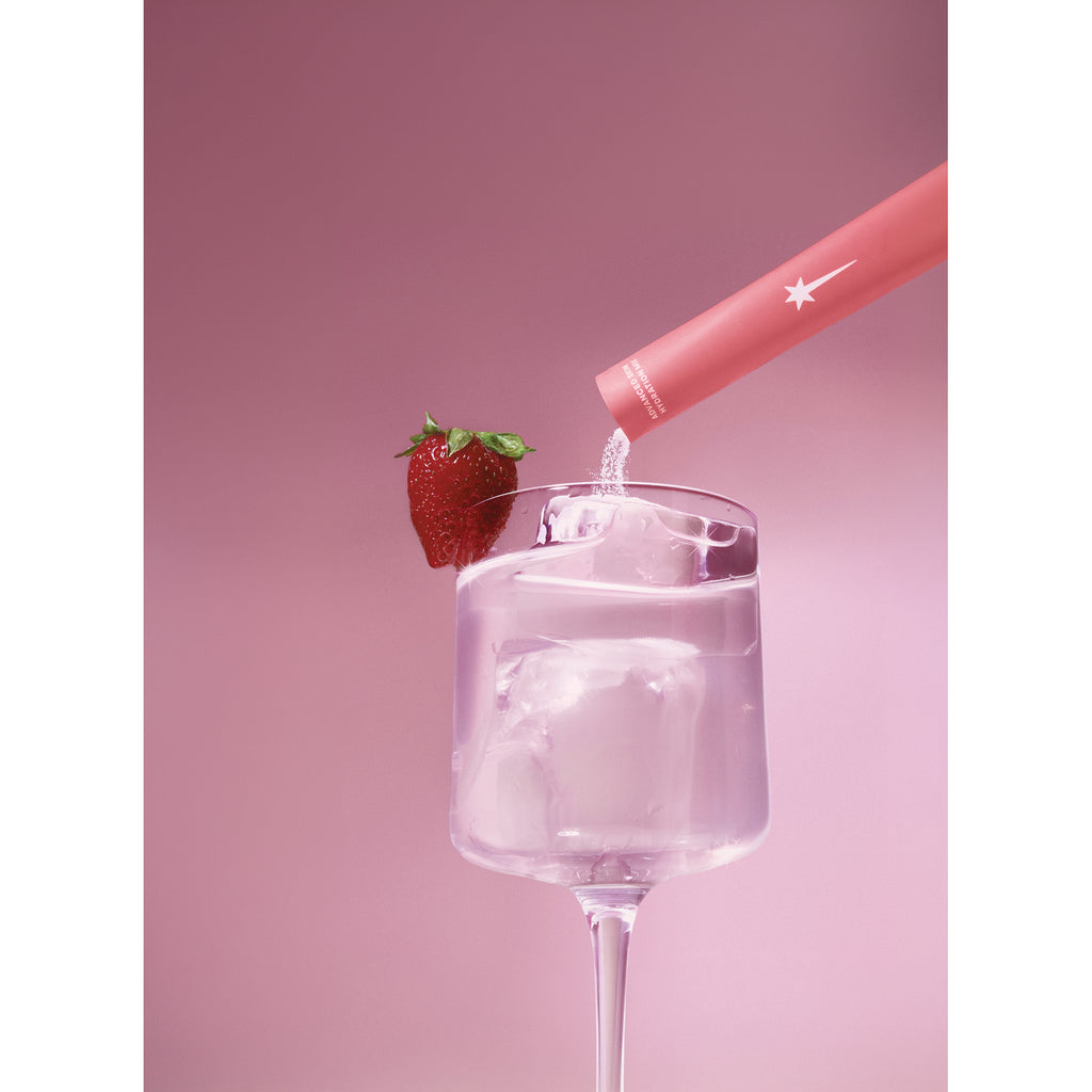 KTO002 | Strawberry powder being poured into a glass of water with a strawberry garnish - Thumbnail