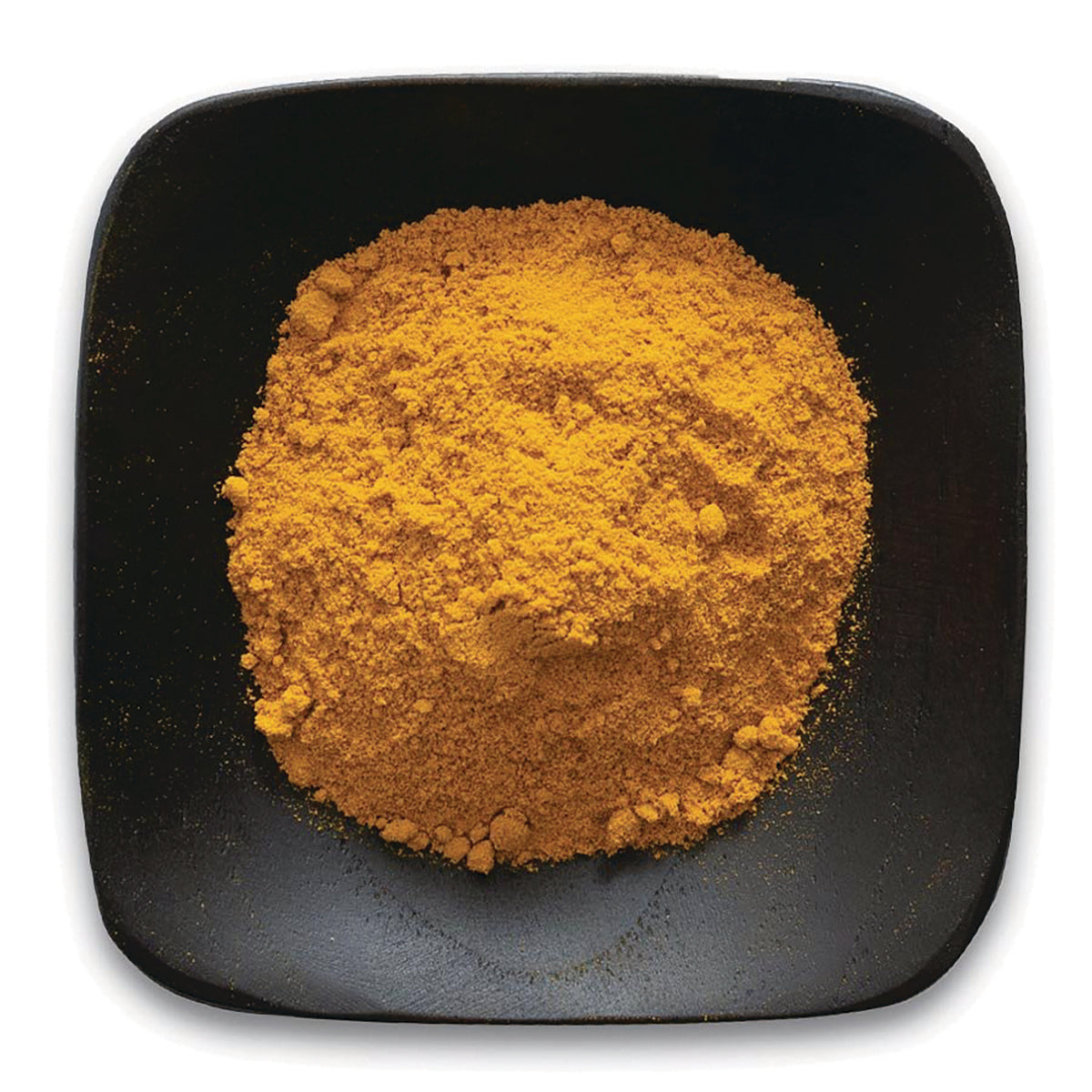 FNP361 | Bright orange turmeric powder piled on a black square plate