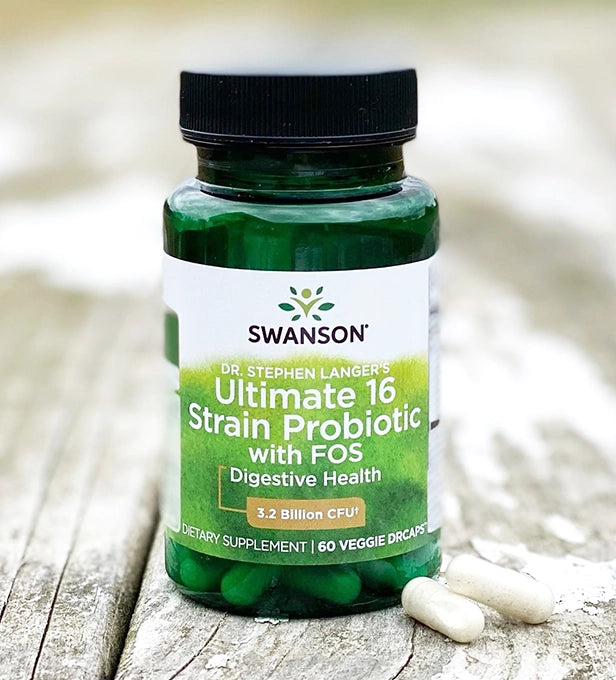 Swanson probiotic supplement bottle on a wooden surface with blurred background