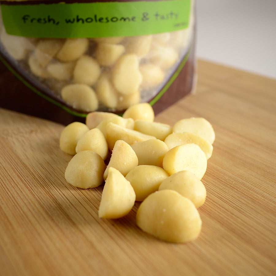 NWF980 | macadamia nuts spilled on a wooden board with a bag labeled Fresh, wholesome & tasty in the background - Thumbnail