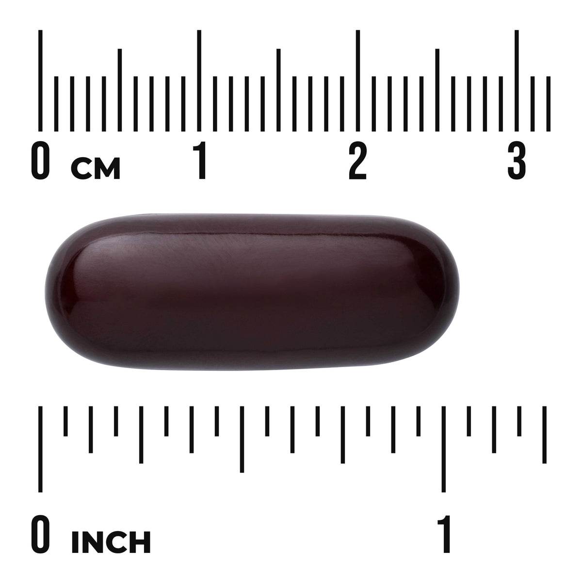 SW882 | Dark softgel capsule shown with centimeter and inch rulers, about 1 inch long