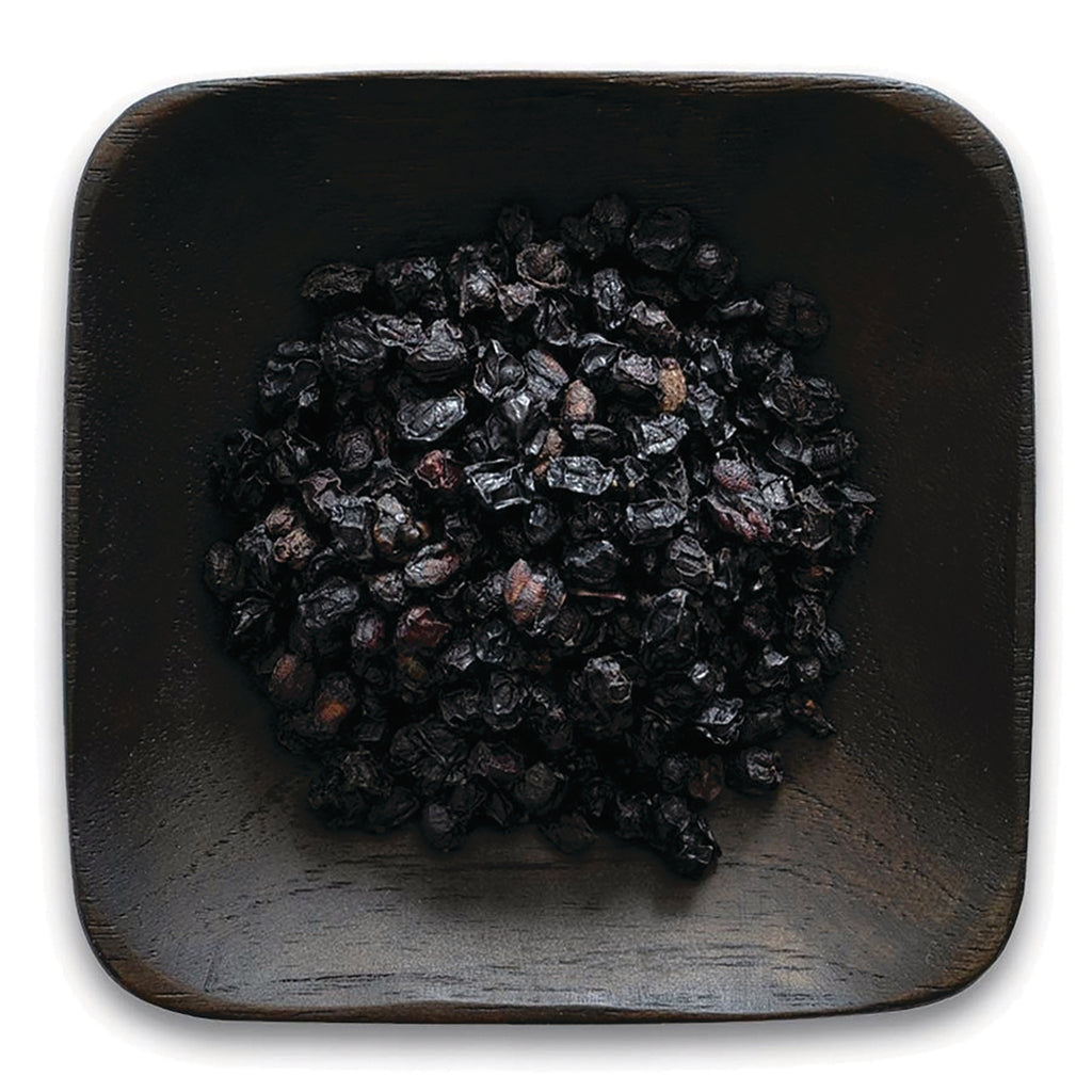 FNP380 | pile of dried dark berries in a square wooden dish on white background - Thumbnail