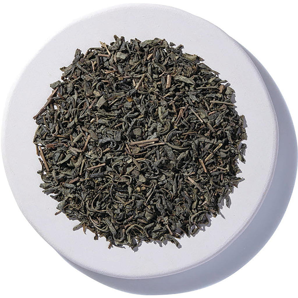 STB028 | Loose leaf green tea on a white dish, top view - Thumbnail
