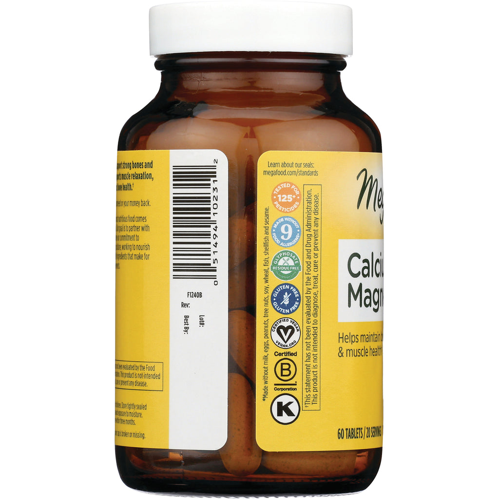 MGF039 | Back of amber supplement bottle with barcode, certification icons, partial label reading Calcium Magnesium and visible tablets - Thumbnail